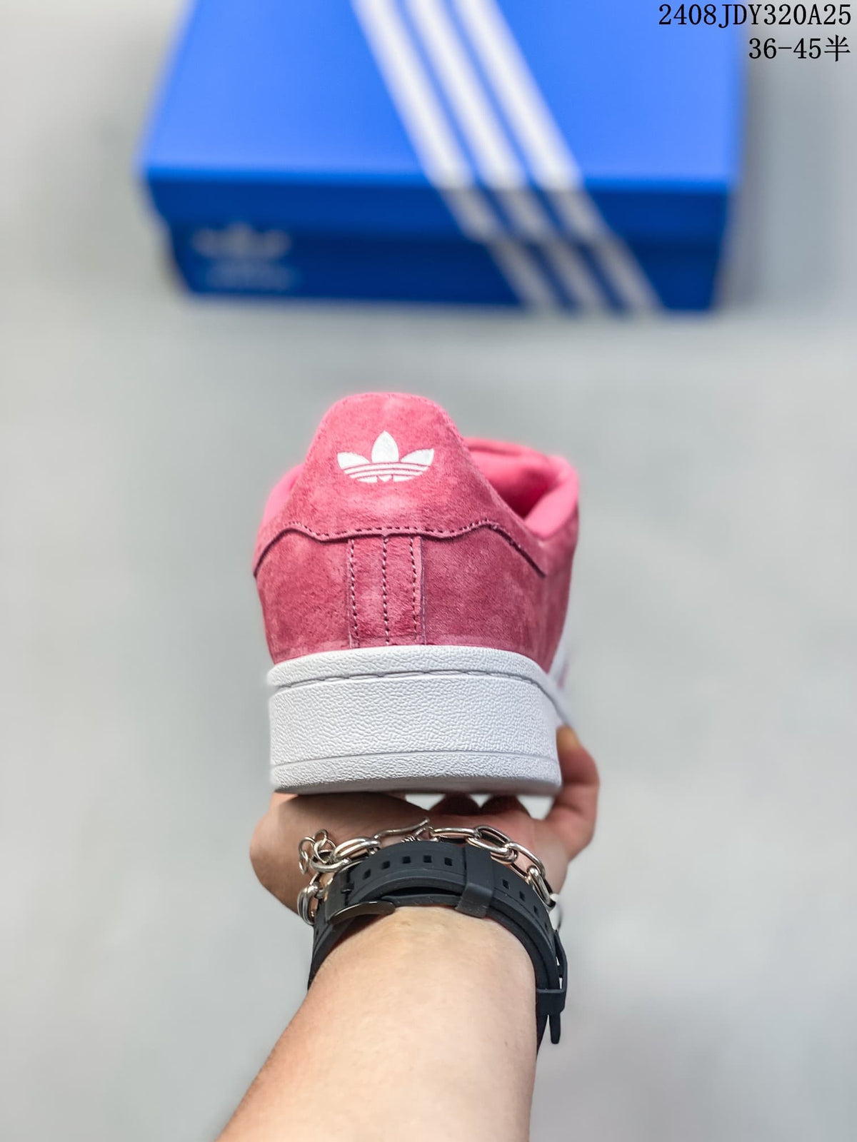 Rear view of a pink sneaker with a white sole and trefoil-style heel mark.