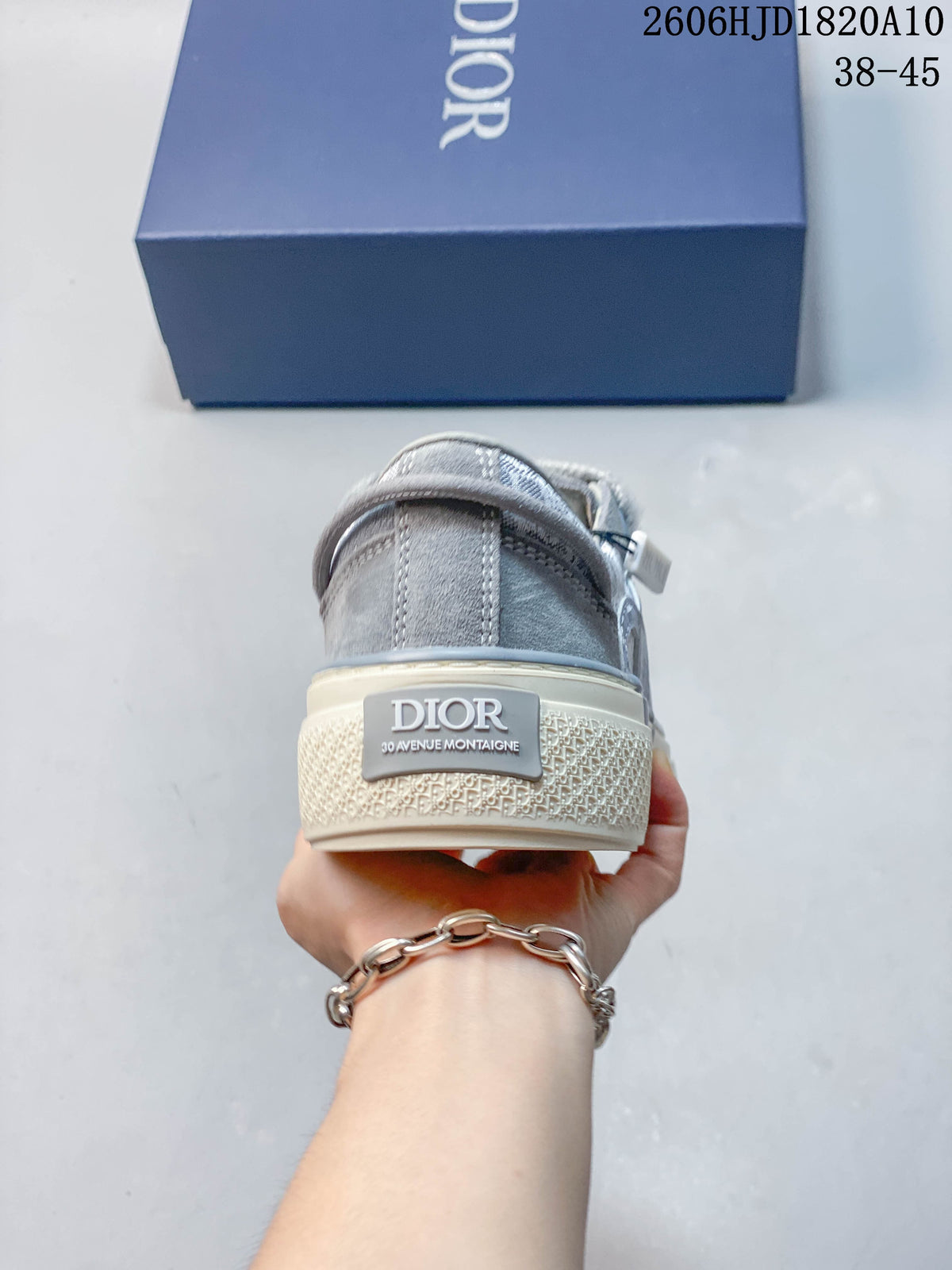 Rear view of a gray sneaker with a branded heel detail