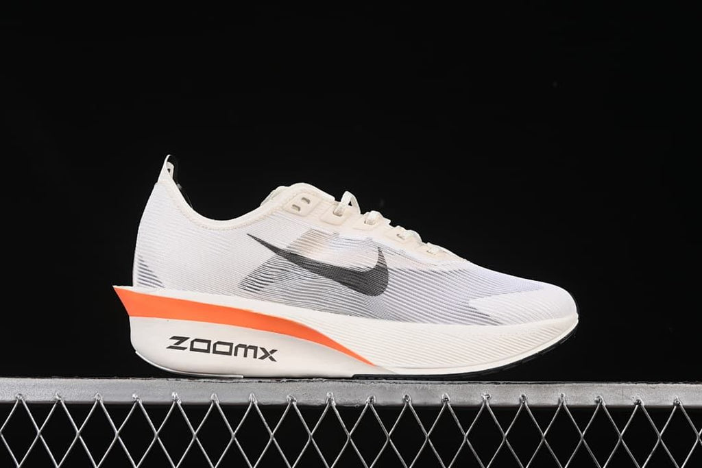 Side profile showing the white upper, black Swoosh, and orange accent.