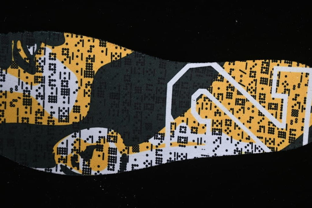 Close-up of a yellow, white, and dark patterned shoe insole