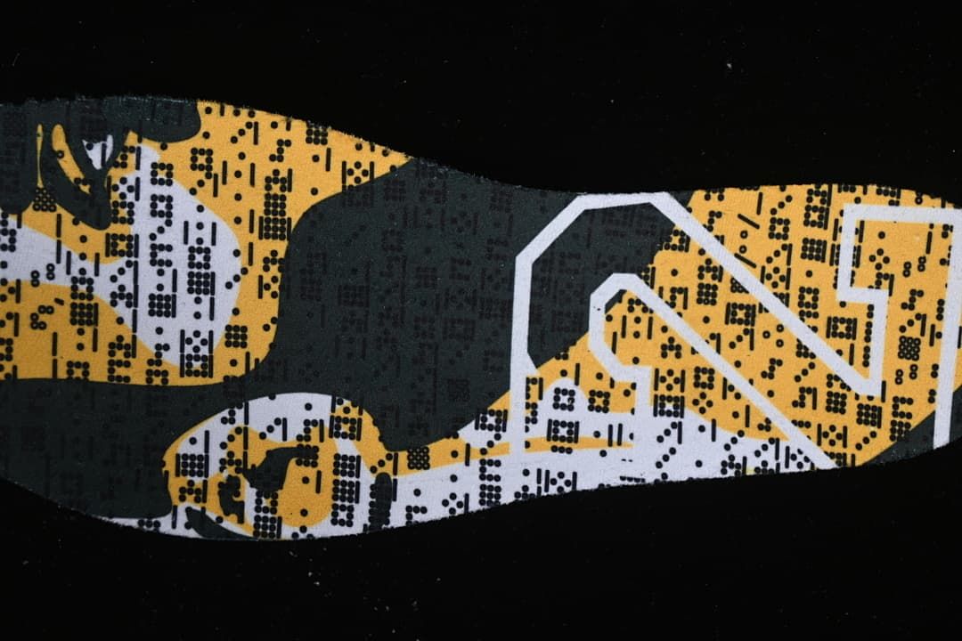 Close-up of a yellow, white, and dark patterned shoe insole