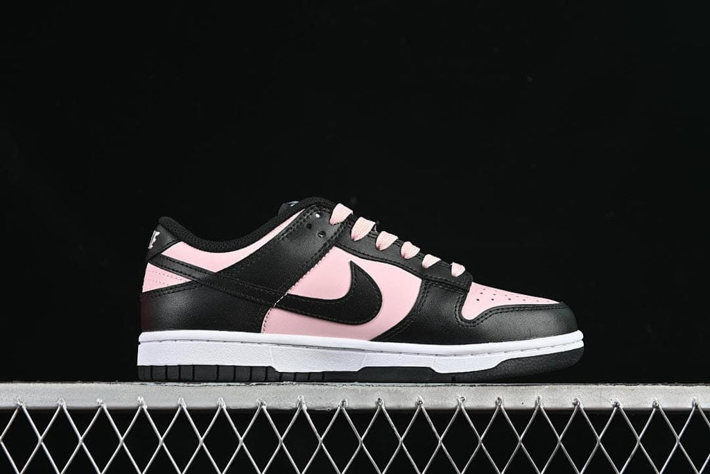 Side profile of a black and pale pink low-top Dunk sneaker