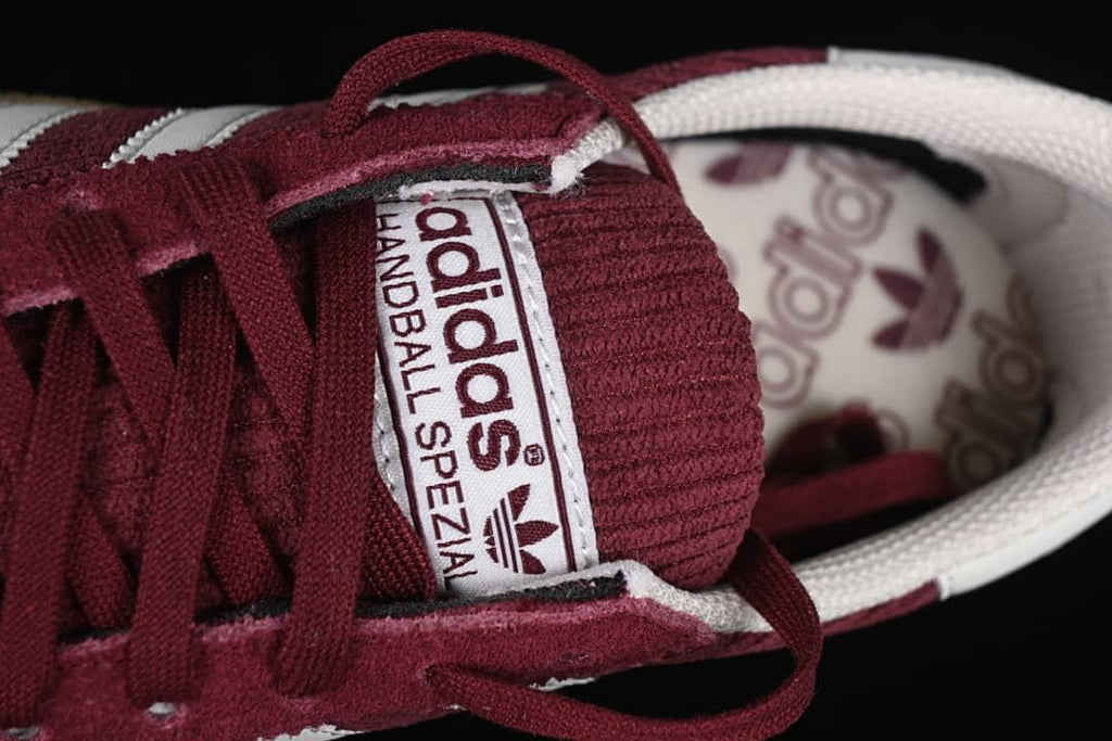 Close-up of the Handball Spezial tongue label and burgundy laces