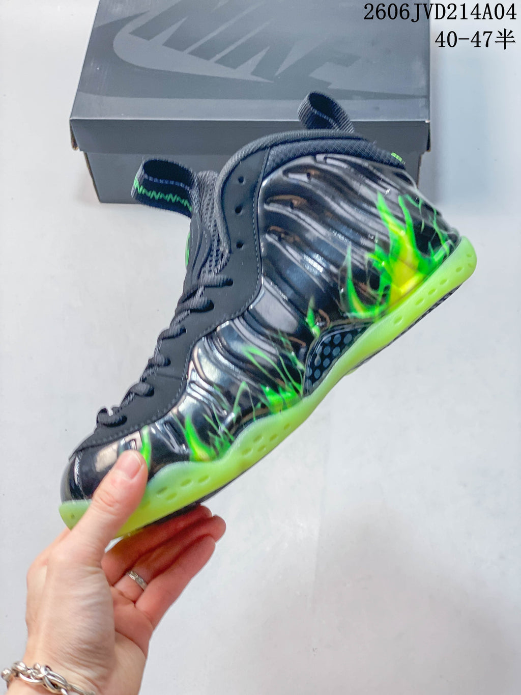 Side profile showing sculpted gray panels, bright green details, and a green outsole.