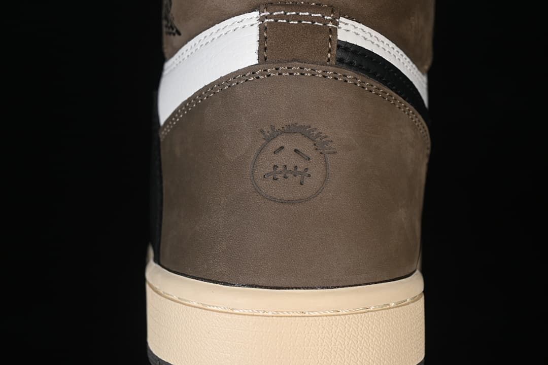 Rear heel detail with brown panel and stitched emblem