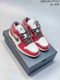 Pair of burgundy, white, and brown Air Jordan 1 Low sneakers displayed on a shoe box