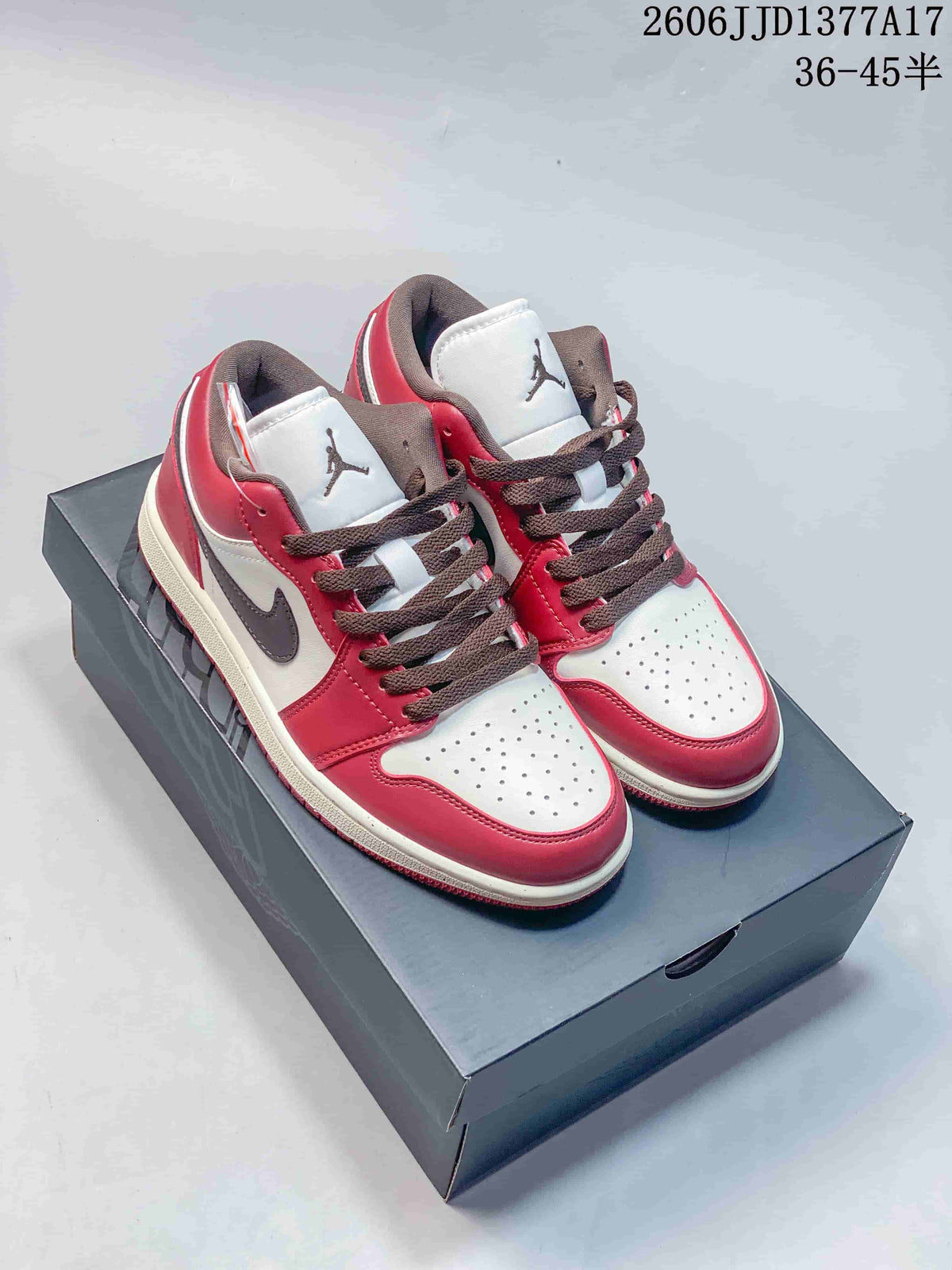 Pair of burgundy, white, and brown Air Jordan 1 Low sneakers displayed on a shoe box