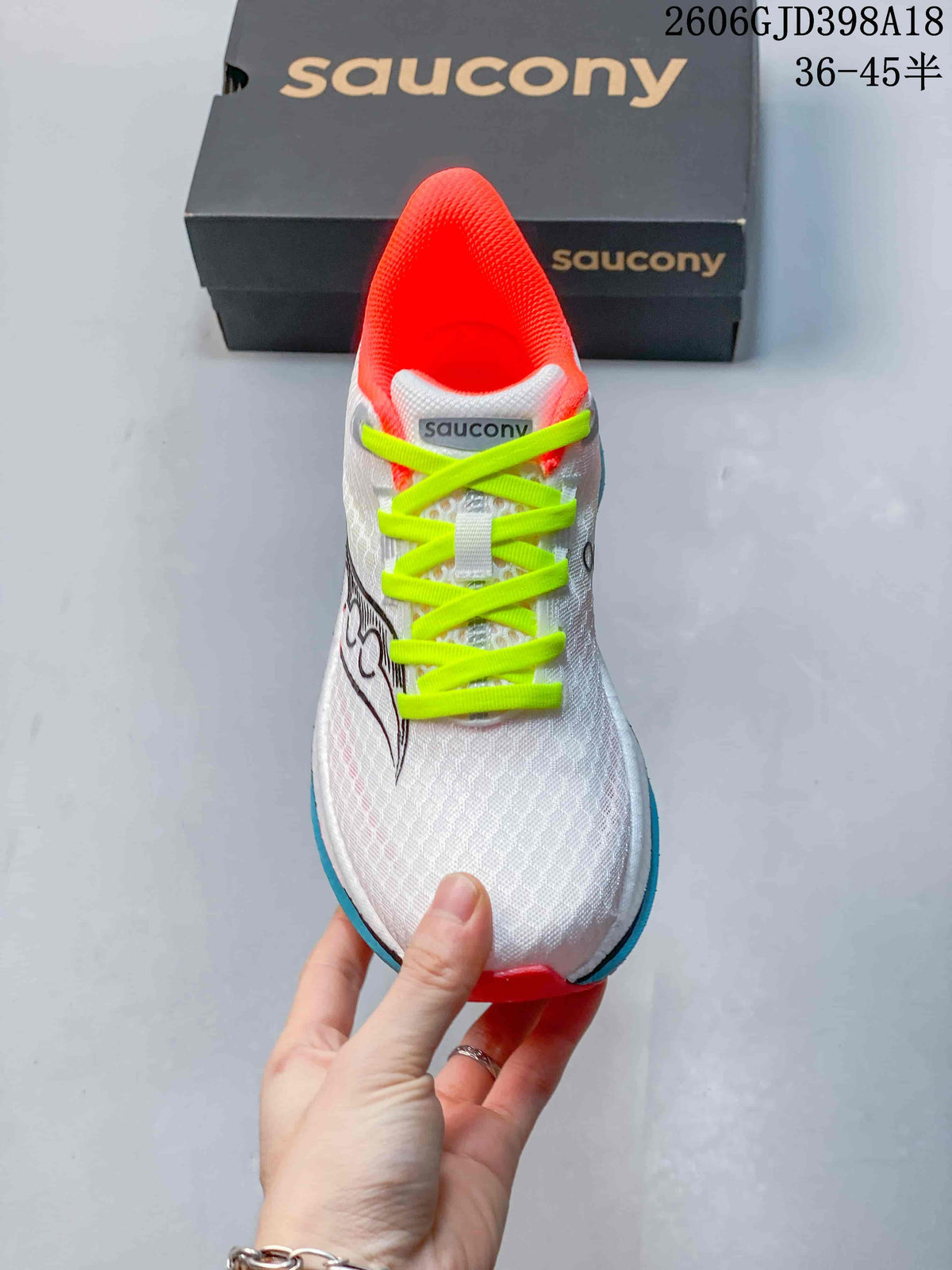 Front view of the Saucony running shoe with bright neon yellow-green laces