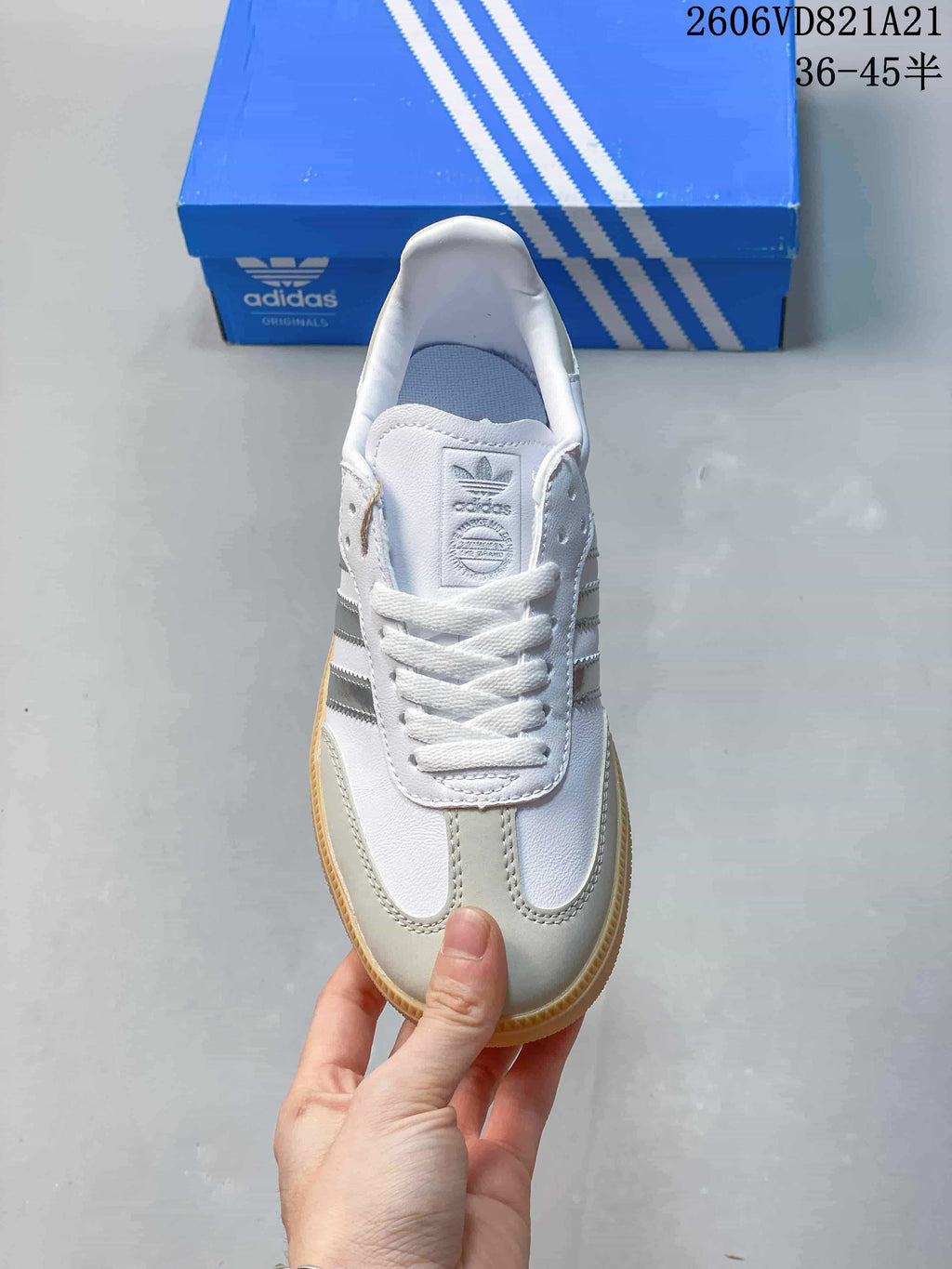 Top view of a white low-top sneaker with light gray overlays and white laces.