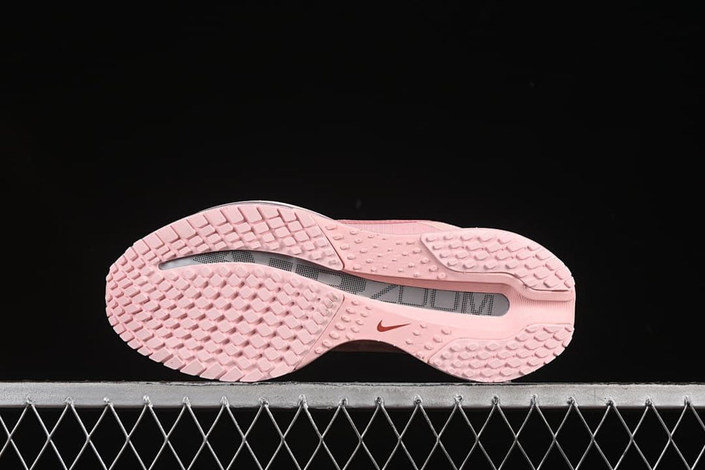Underside of the pink shoe showing the tread pattern