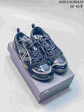 Pair of dark navy New Balance MT10O low-top sneakers displayed on a box