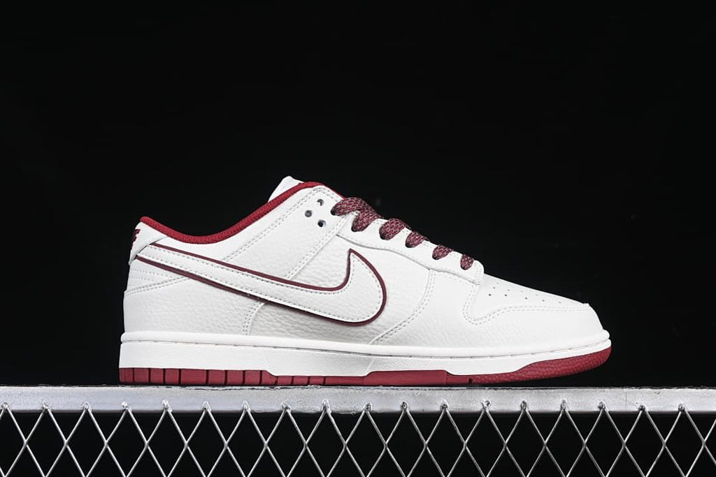 Side profile of a white and burgundy low-top sneaker