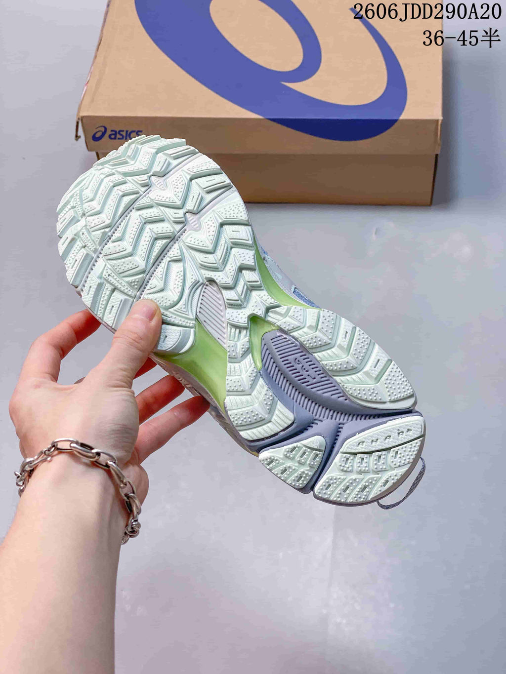 Close view of the shoe outsole showing a deeply patterned tread.