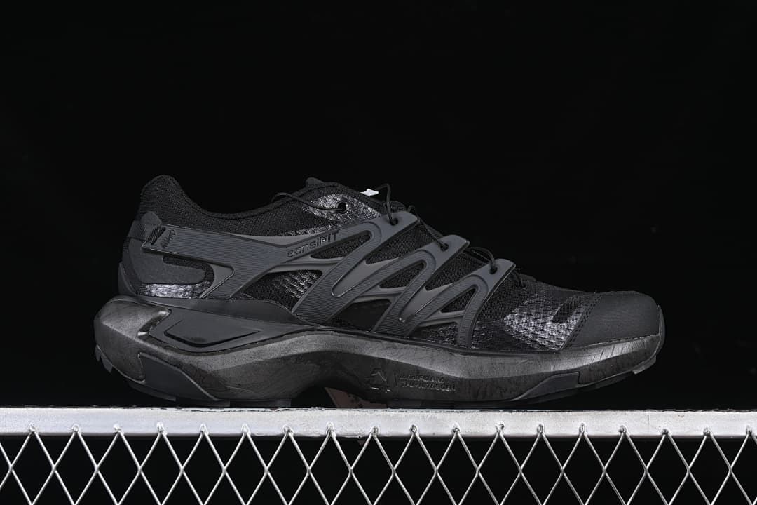 Side profile of a black and dark grey shoe.