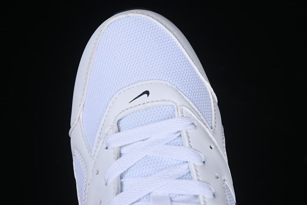 Top view of the white mesh-look toe and lace area.