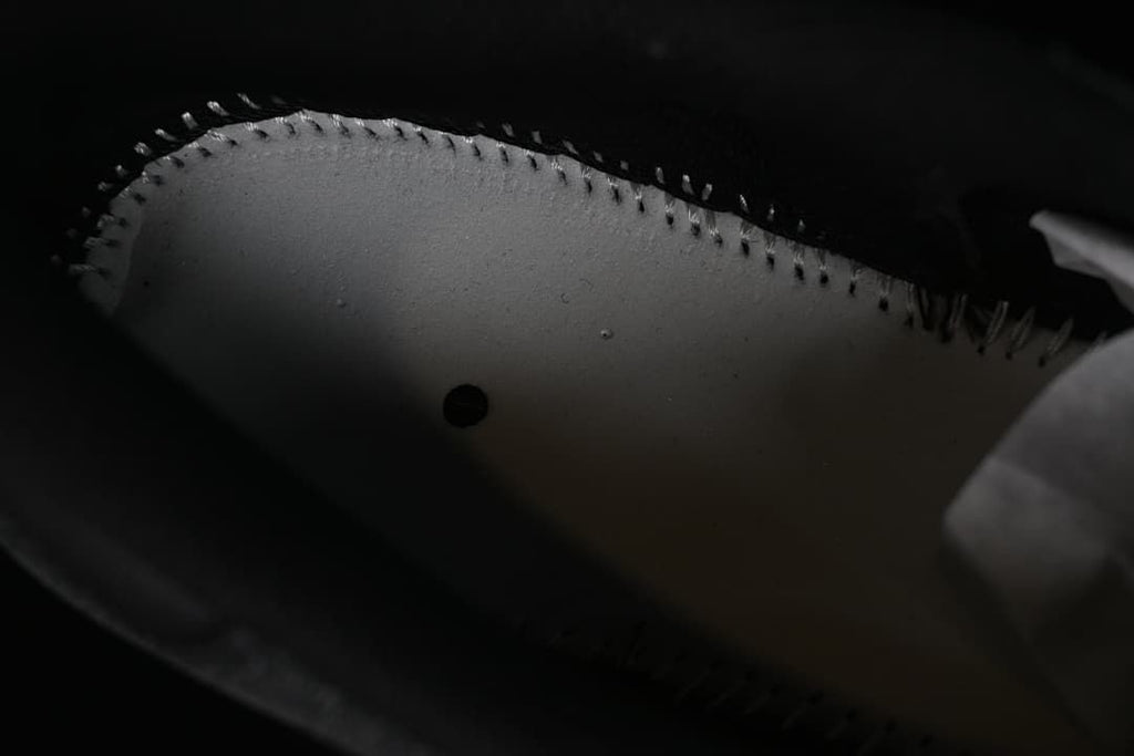 Close-up inside the sneaker showing the underside of the upper and stitching