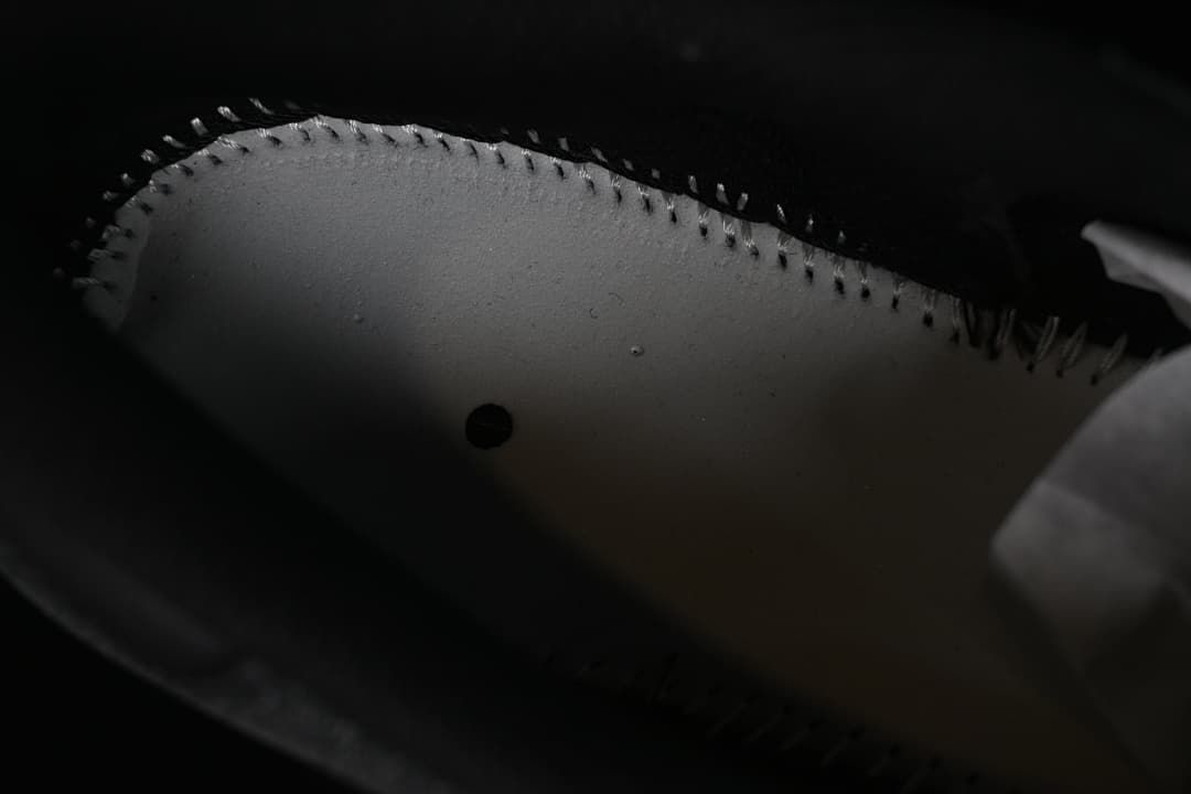 Close-up inside the sneaker showing the underside of the upper and stitching