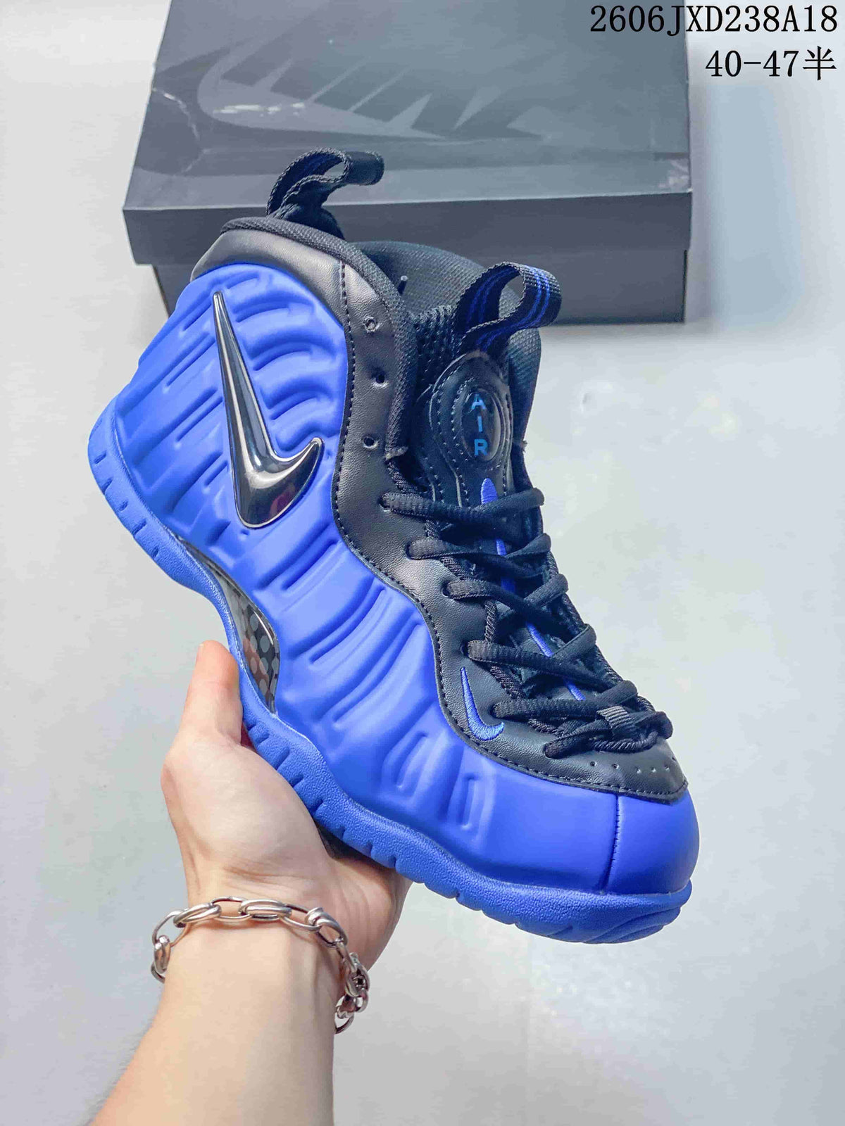 Angled side view of the blue and dark Nike Foamposite Pro sneaker