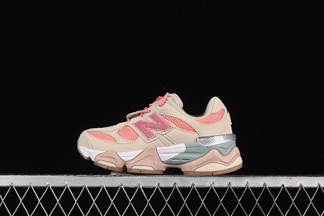 Side view of beige and pink New Balance kids' sneakers