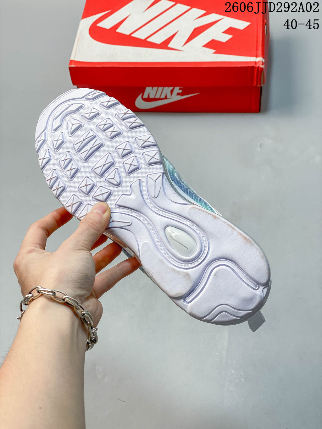 Underside of a Nike Air Max 97 sneaker showing its white tread pattern