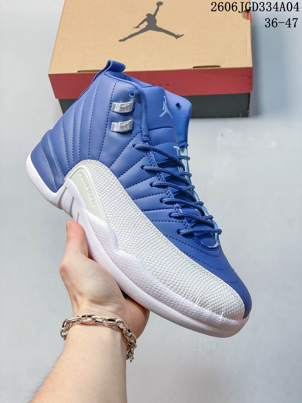 Close side view of a blue and white Jordan Air Jordan 12 high-top shoe