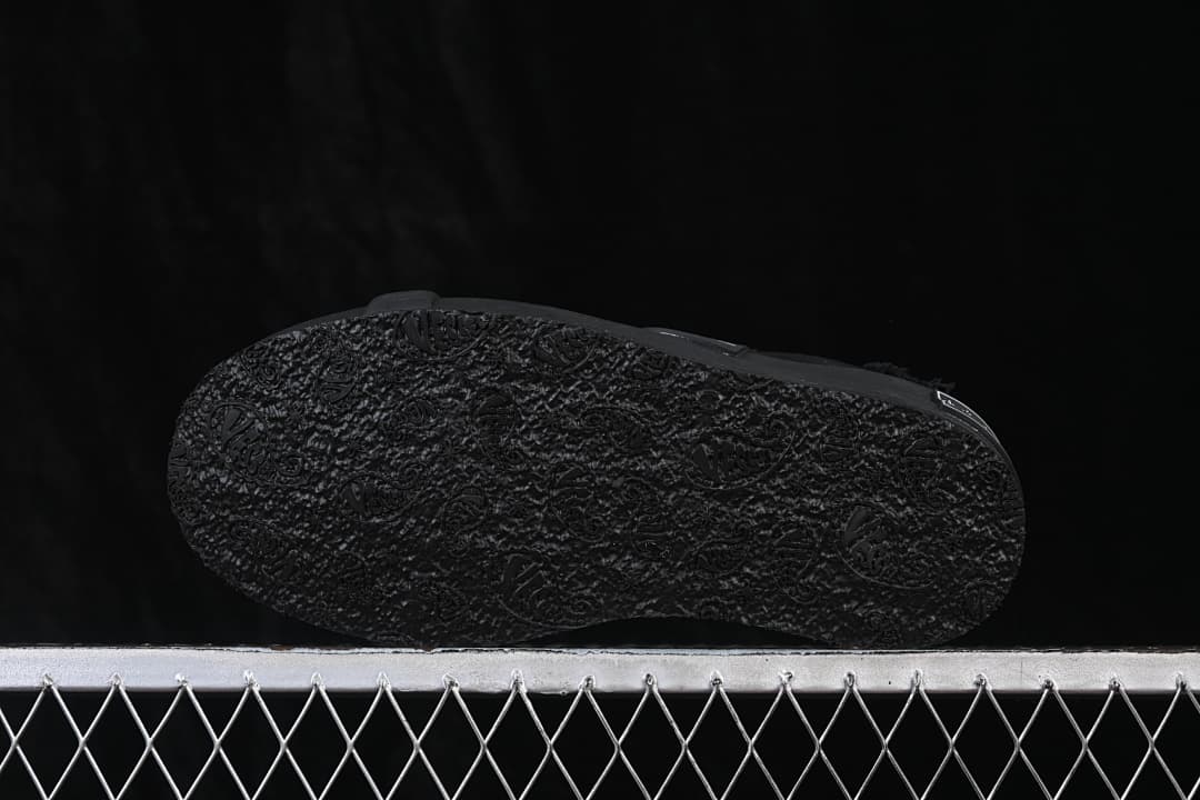 Underside of the black sneaker with a textured outsole