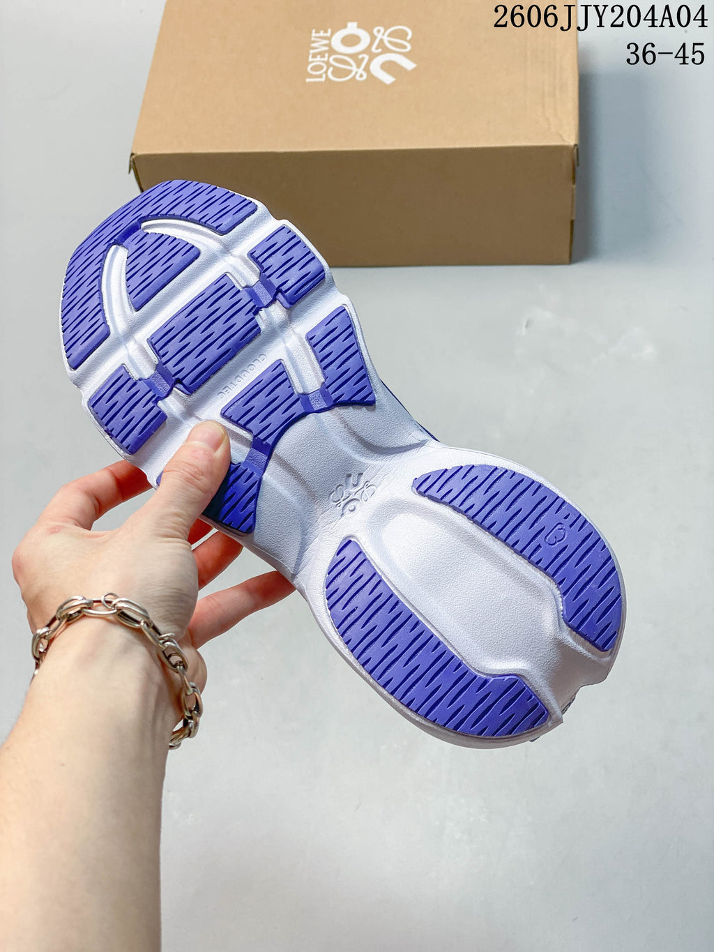Underside view showing the blue-and-white sneaker outsole.