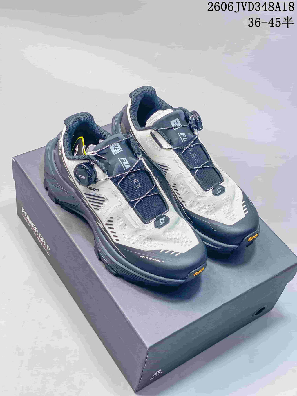 Pair of white and gray Kailas FUGA EX3 trail running shoes on a shoebox