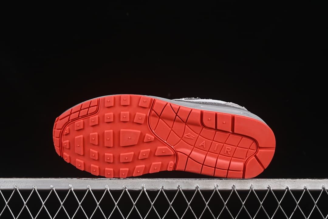 Underside view showing the bright crimson patterned outsole.