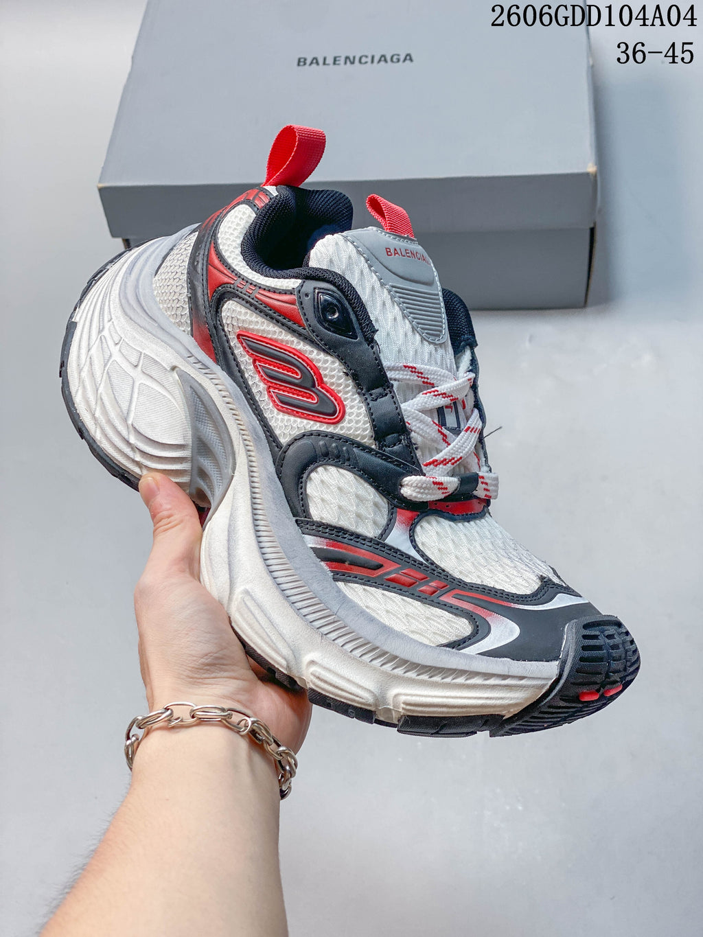 Angled side view of the sneaker with red and navy detailing