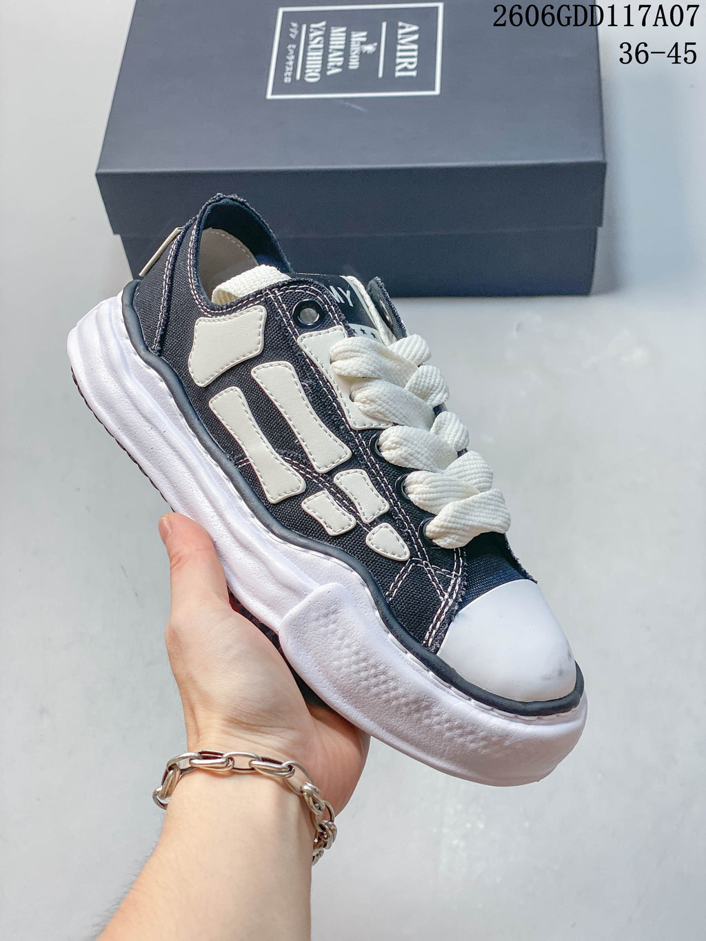 Angled view of the navy and white low-top sneaker