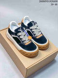 Pair of navy low-top sneakers with cream laces, white midsoles, and gum-colored outsoles