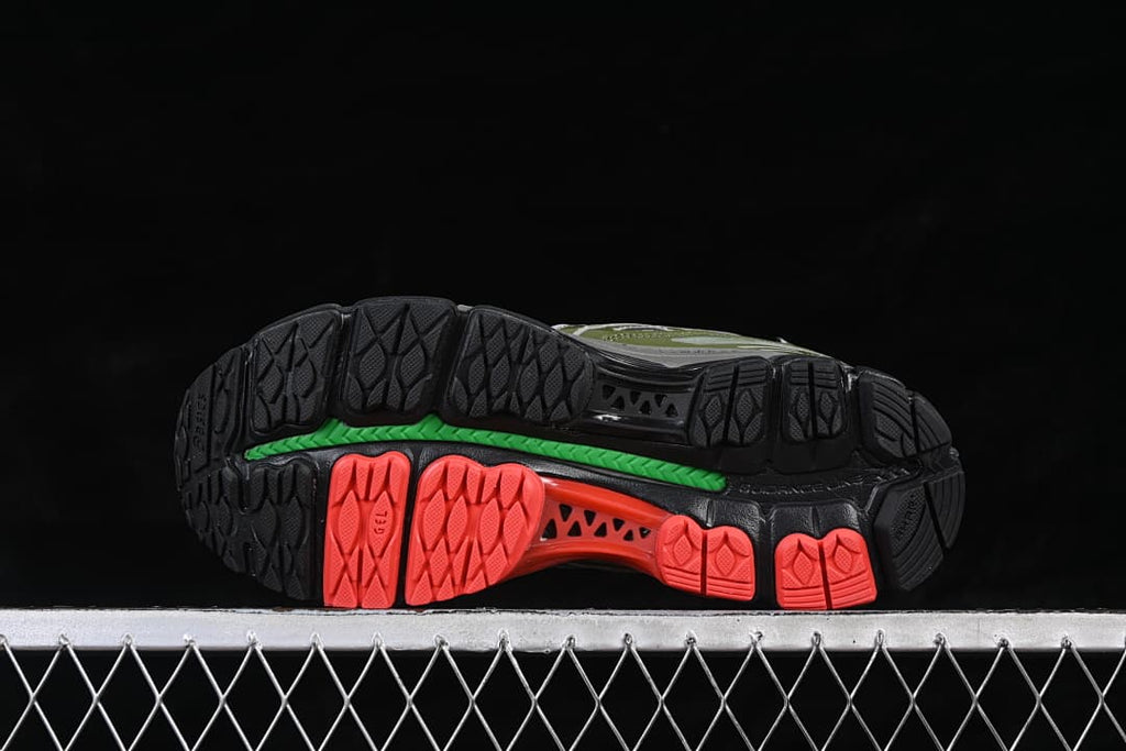 Underside view showing the segmented black, coral, and green outsole.