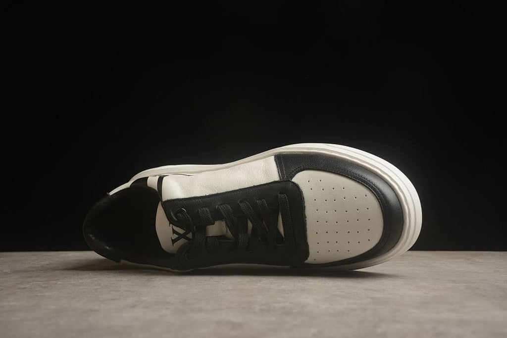 Top view of the sneaker showing the laces and perforated toe