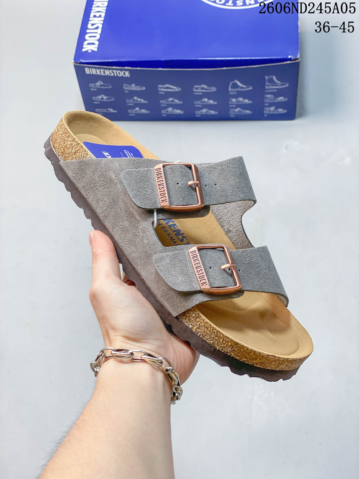 Gray two-strap sandal with copper-tone buckles and contoured footbed.