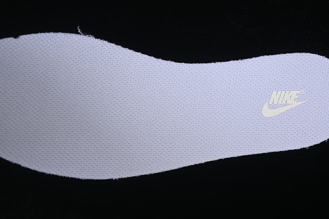 Close-up of a textured shoe insert with Nike branding