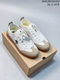 Pair of white DESCENTE Chron Pacer CVS sneakers with beige overlays and gum-colored soles