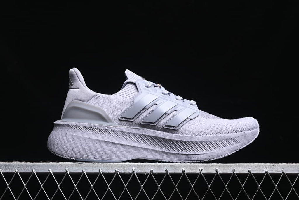 Side profile of a light grey Adidas Ultraboost 5 shoe