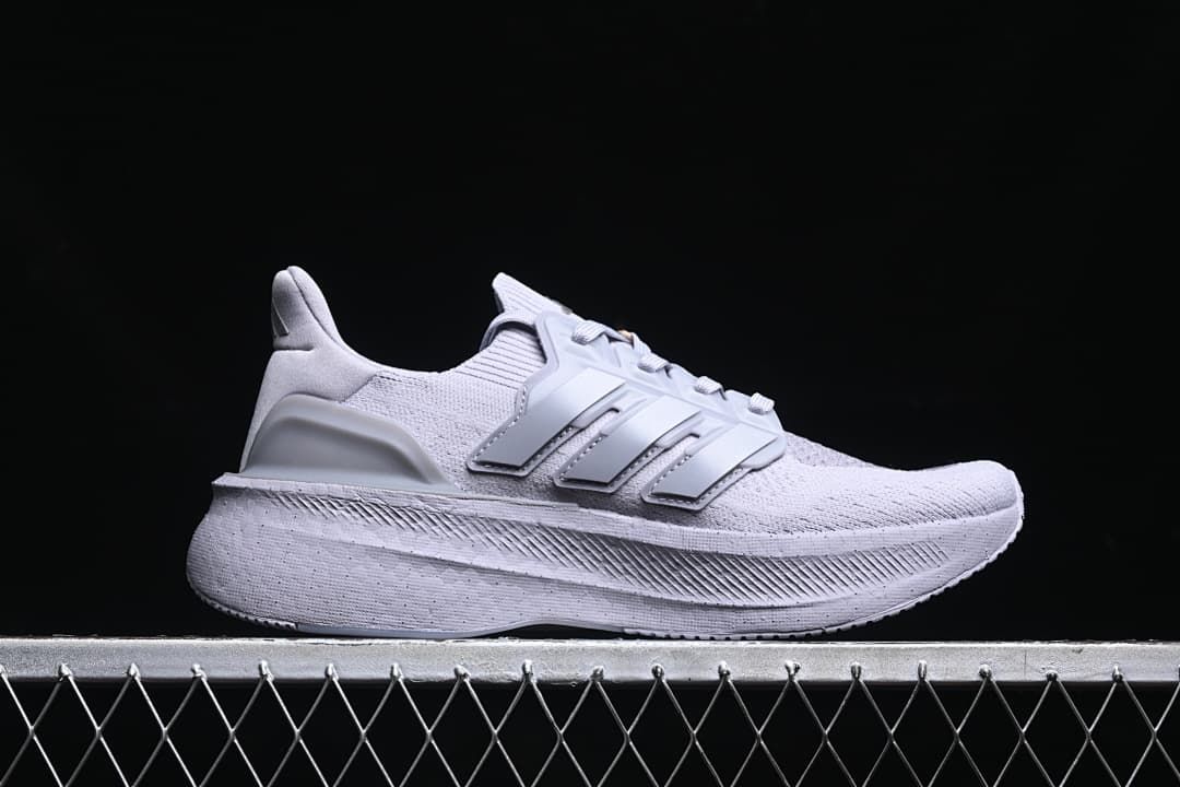 Side profile of a light grey Adidas Ultraboost 5 shoe
