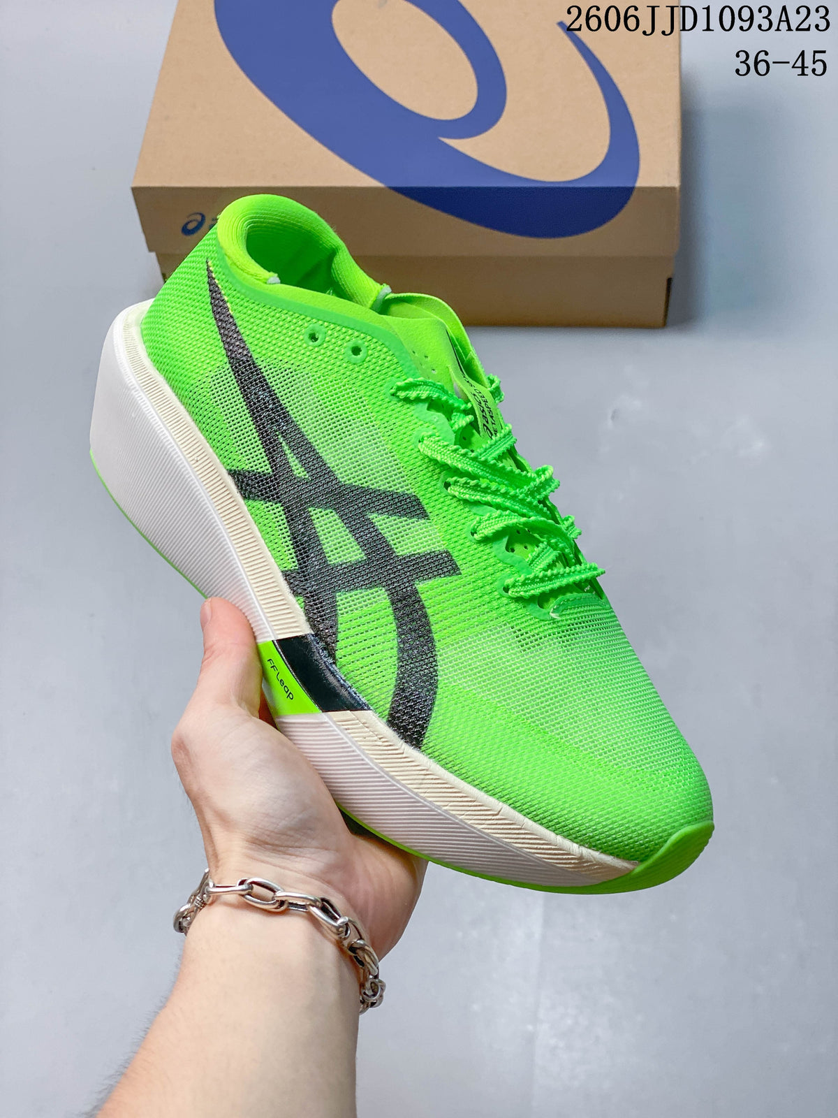 Close side view of the bright green running shoe with dark ASICS stripes