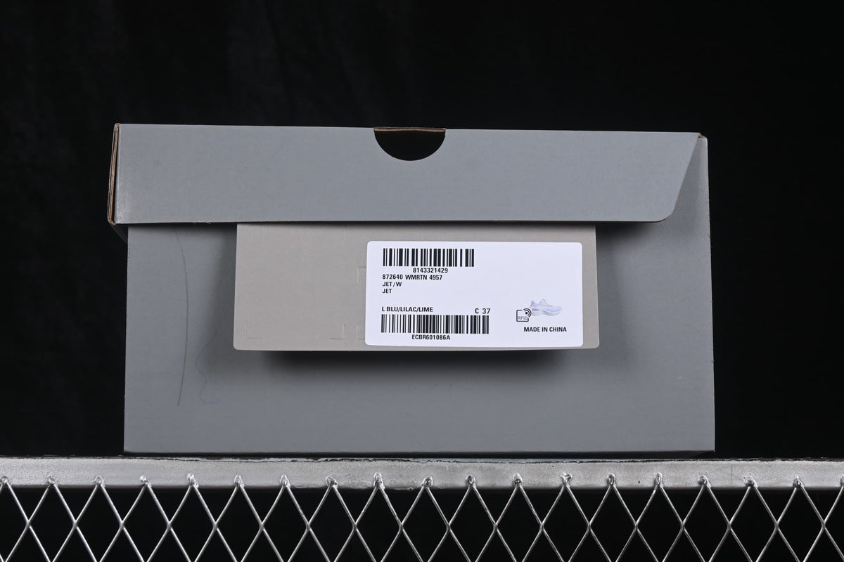 Gray shoe box with a label showing Jet, WMRTN 4957, L BLU/LILAC/LIME and size C 37.