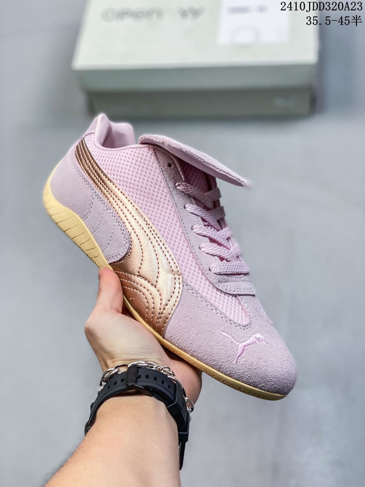 Angled side view of the pink sneaker with metallic bronze stripe and removable tongue flap