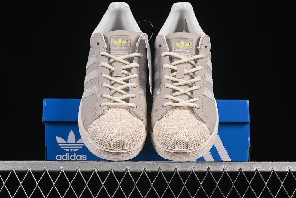 Front view of the pair showing shell toes, laces and stripe detailing.