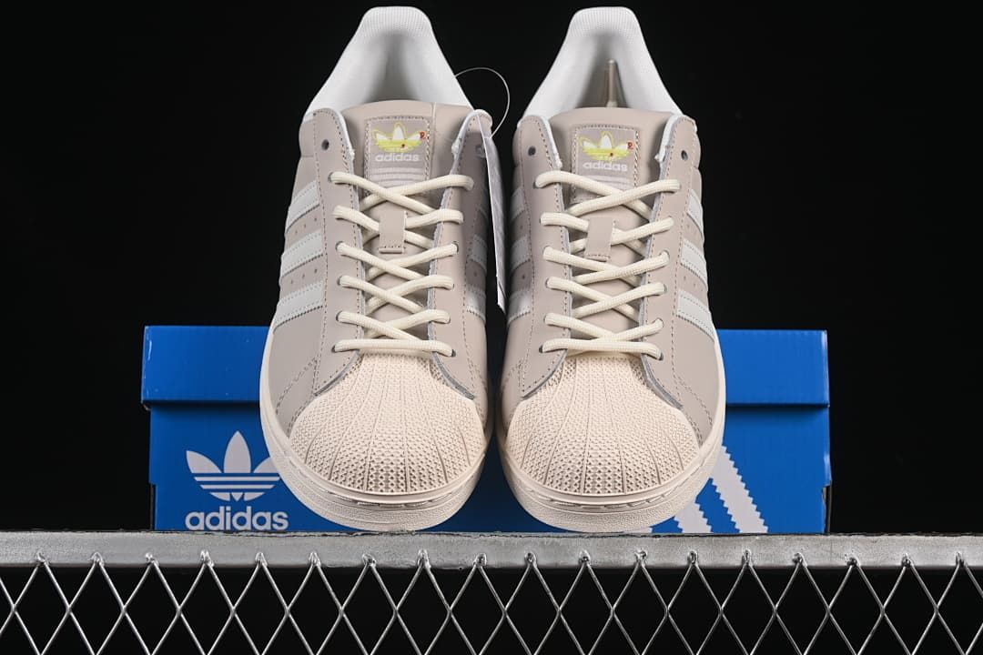 Front view of the pair showing shell toes, laces and stripe detailing.