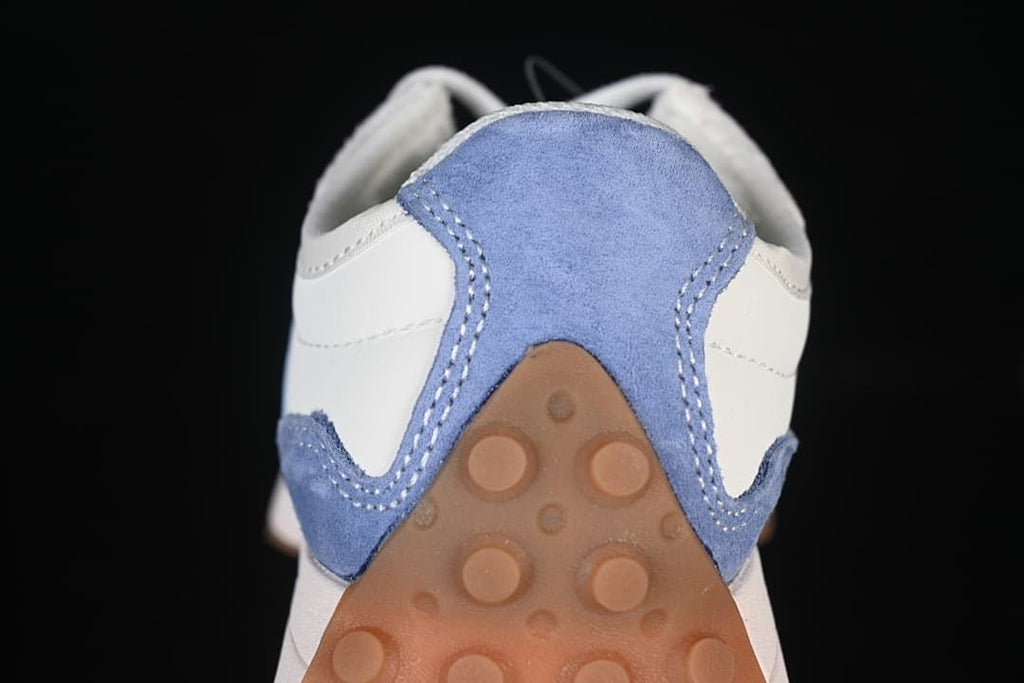 Close-up of the blue heel panel and gum-colored outsole.