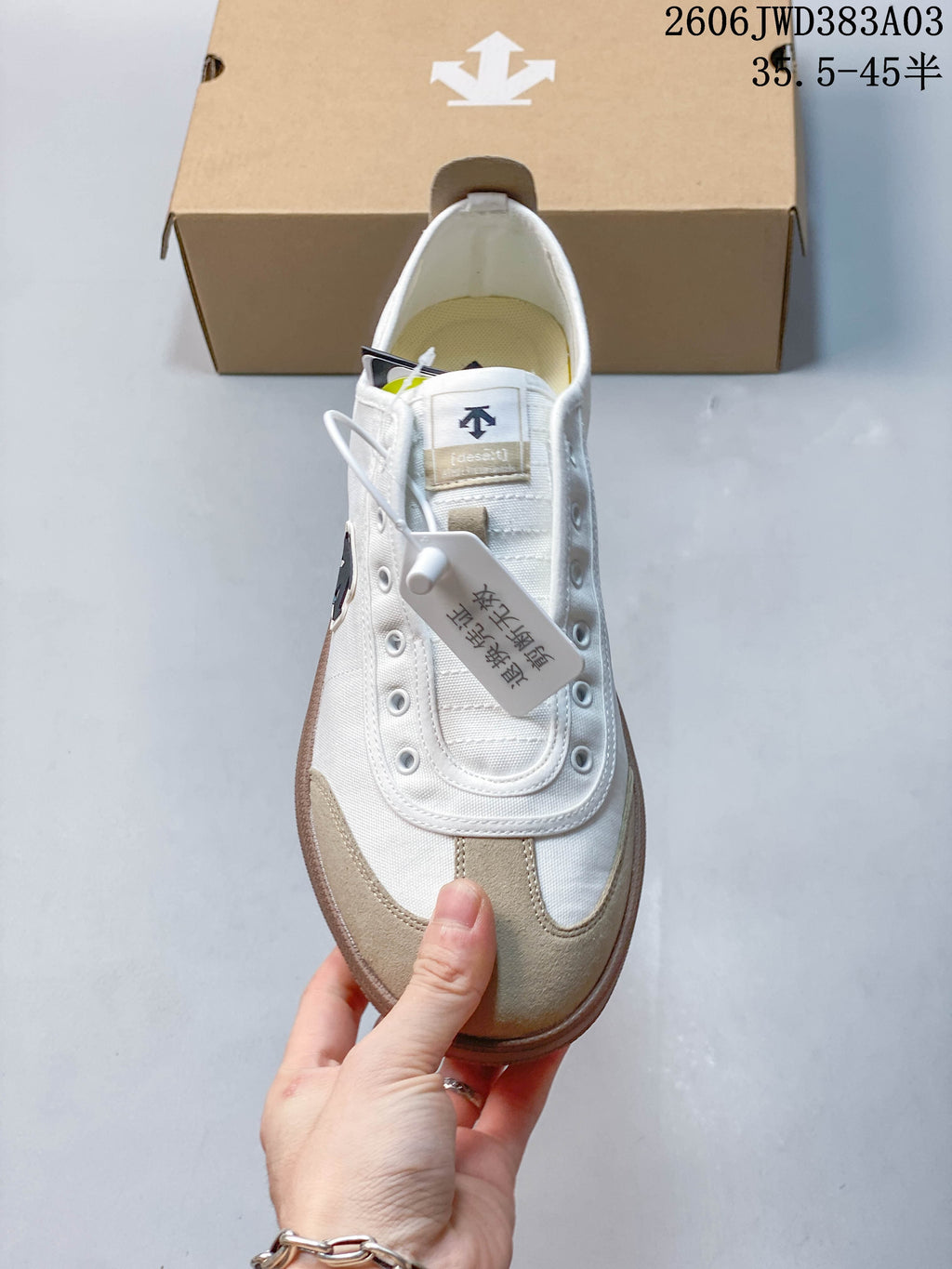 Front view of the sneaker showing its extended eyelet panel and beige toe overlay