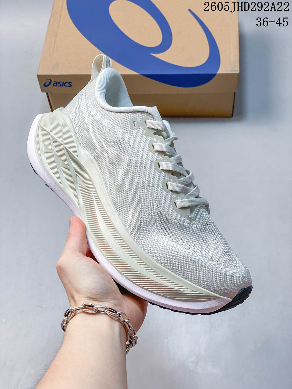 Off-white ASICS Superblast 2 Paris running shoe with cream-colored midsole details.
