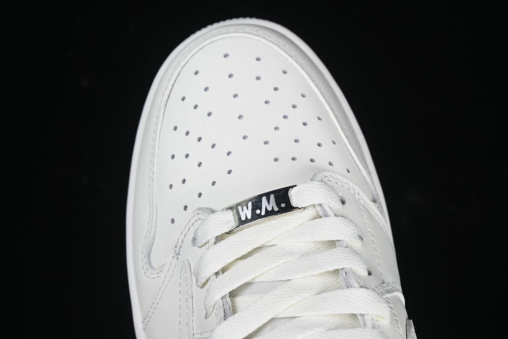 Top view of the perforated toe, white laces, and lace tag.