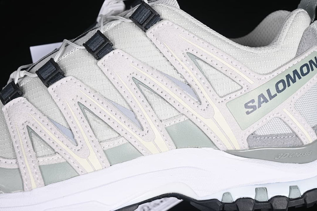 Close-up of the side overlays, branding and lugged outsole edge