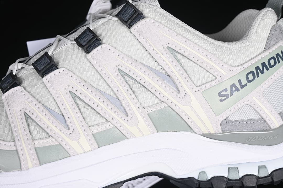 Close-up of the side overlays, branding and lugged outsole edge